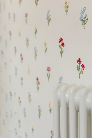 multicolour floral pattern stencil on cream wall