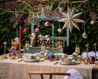 Al fresco Christmas dining with colourful details and DIY spray painted feature branch and flowers