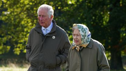 Queen Elizabeth II and Britain's Prince Charles, Prince of Wales walk to the Balmoral Cricket Pavilion