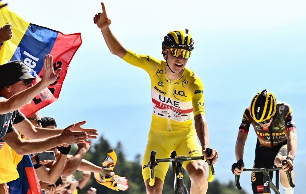 UAE Team Emirates teams Slovenian rider Tadej Pogacar wearing the overall leaders yellow jersey C celebrates as he cycles past JumboVisma teams Danish rider Jonas Vingegaard R to win the 7th stage of the 109th edition of the Tour de France cycling race 1763 km between Tomblaine and La Super Planche des Belles Filles in eastern France on July 8 2022 Photo by Marco BERTORELLO AFP Photo by MARCO BERTORELLOAFP via Getty Images