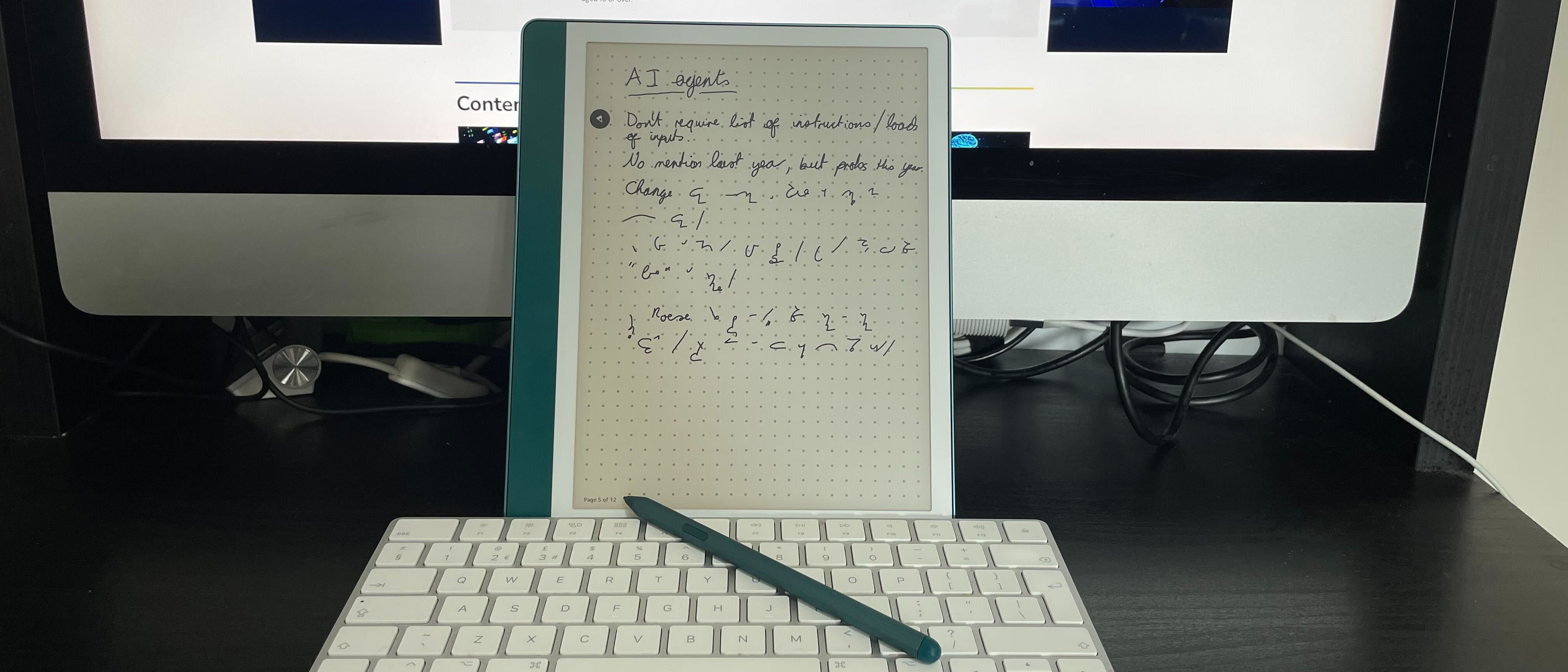 The Amazon Kindle Scribe tablet and stylus on a desk on a desk