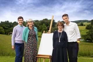 The Big Painting Challenge judges pose with an easel