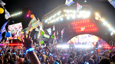 A huge crowd dances at the Pyramid Stage as Coldplay perform