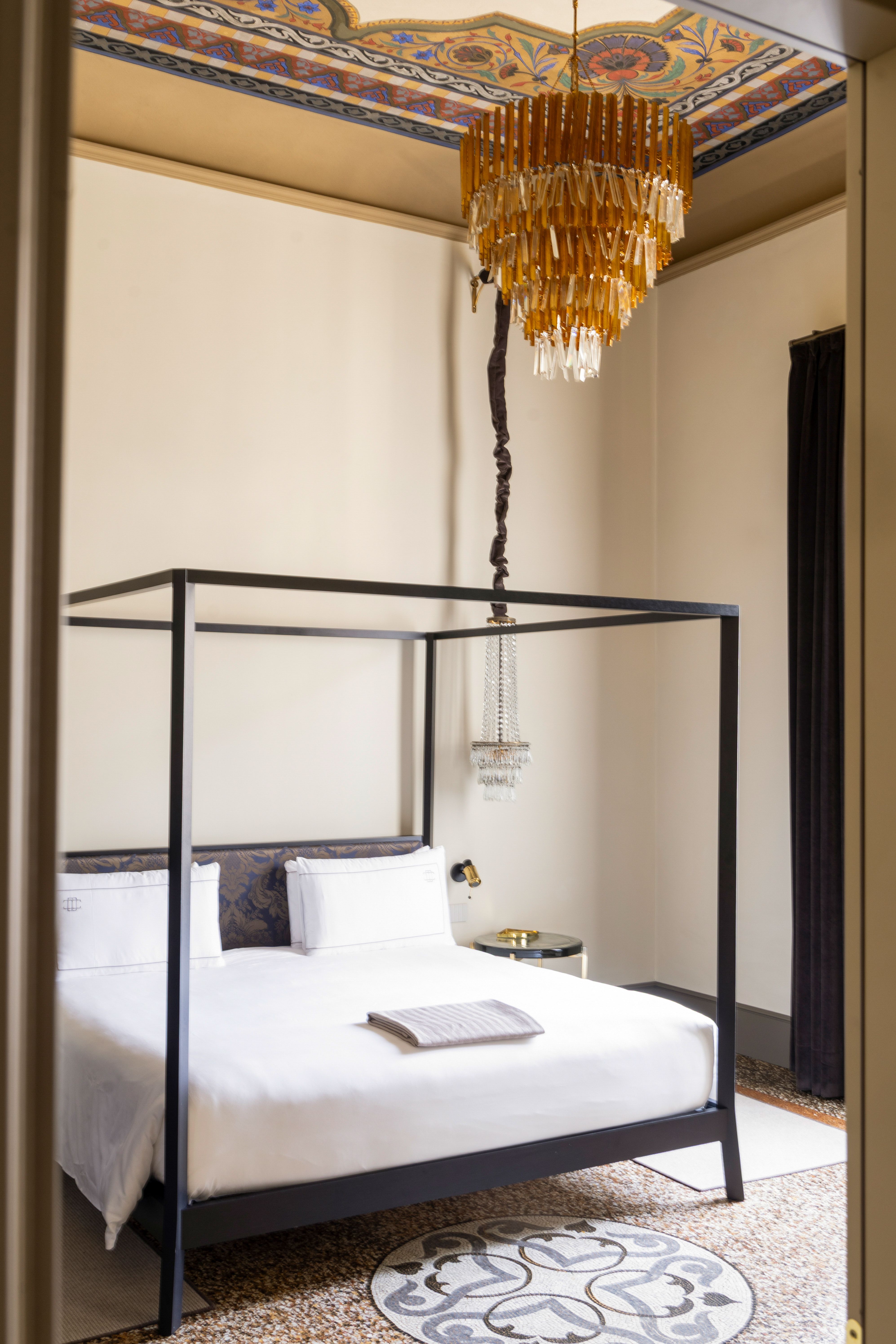 An ornate, palatial residence filled with sunshine, frescoed walls, terrazzo floors, vintage, modern, and plush contemporary furnishings, and thriving plants, whether indoors or on its terrace.