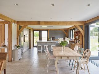 modern kitchen in oak frame home with dining area