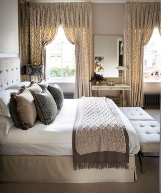 A luxurious bed and gold patterned drapes illustrated cozy bedroom ideas.