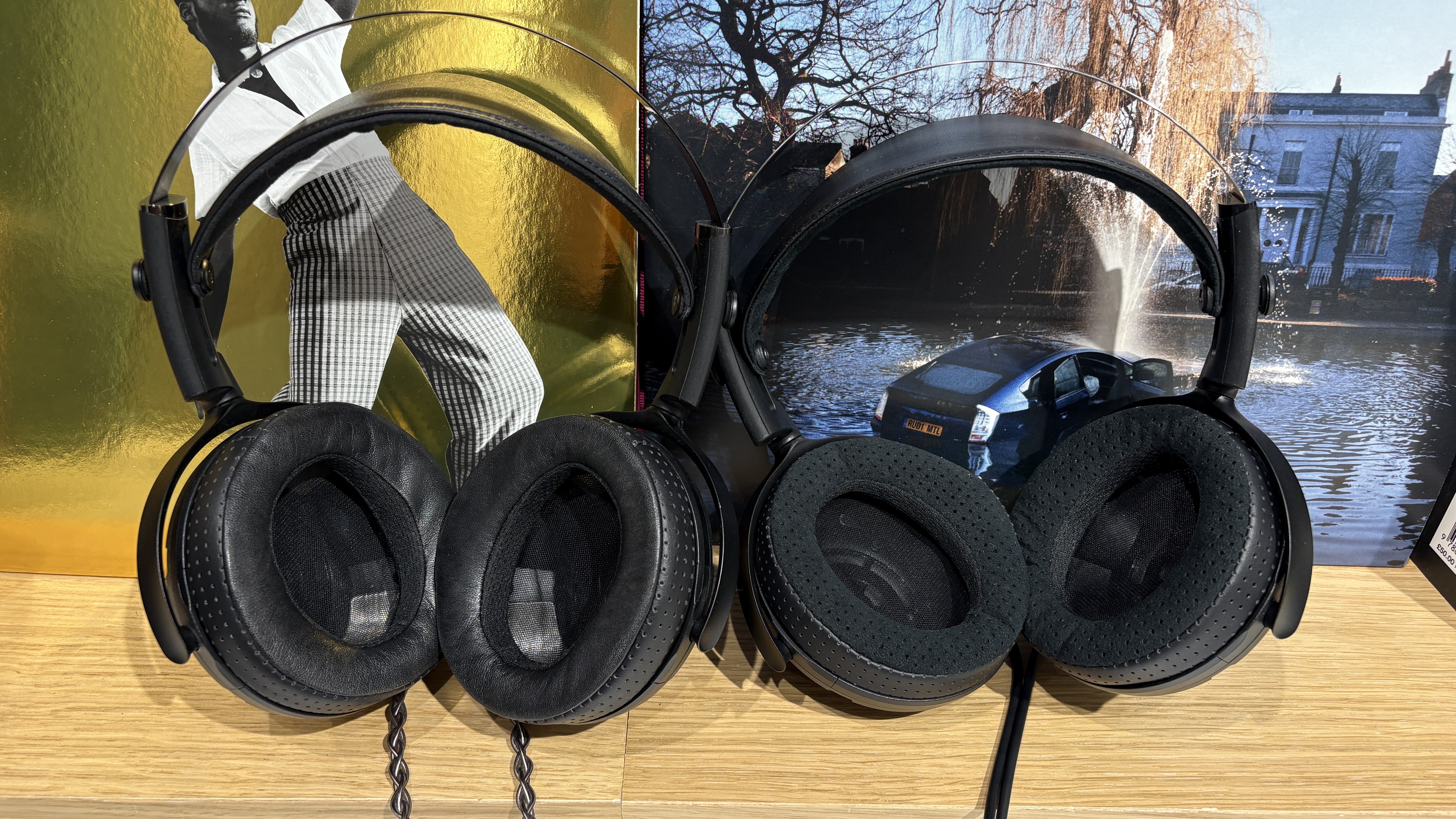 Yamaha YH-5000SE and YH-4000 headphones side-by-side on a desk with vinyl records in background