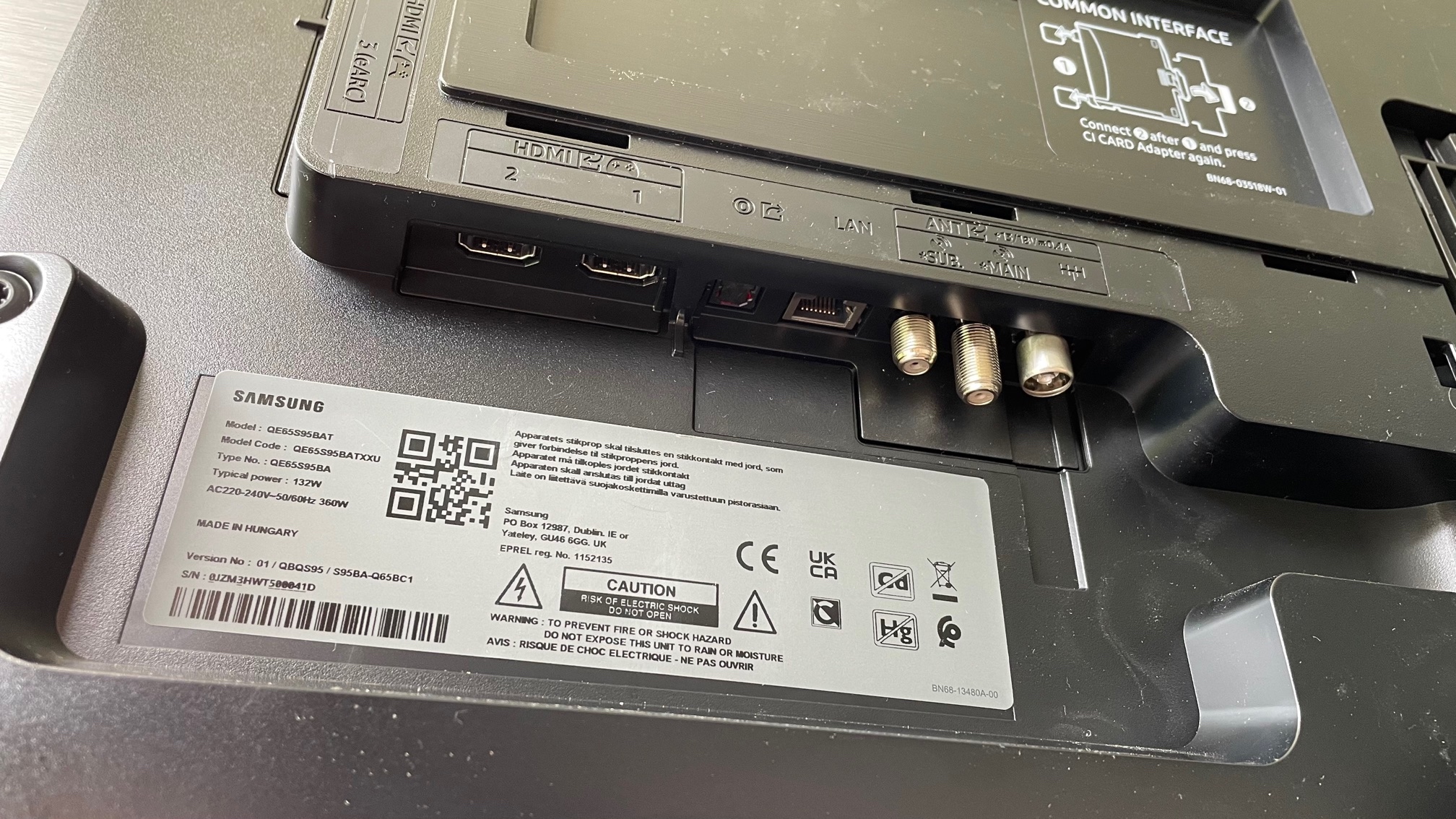 Samsung S95B OLED TV rear panel connections on table