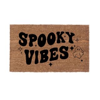 A Halloween doormat that says 