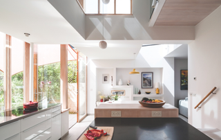 Inside the kitchen with windows to the left overlooking the garden