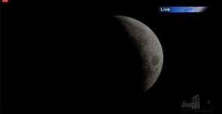 The moon nears the peak of a total lunar eclipse on Oct. 8, 2014 in this view from Griffith Observatory in Los Angeles, California.