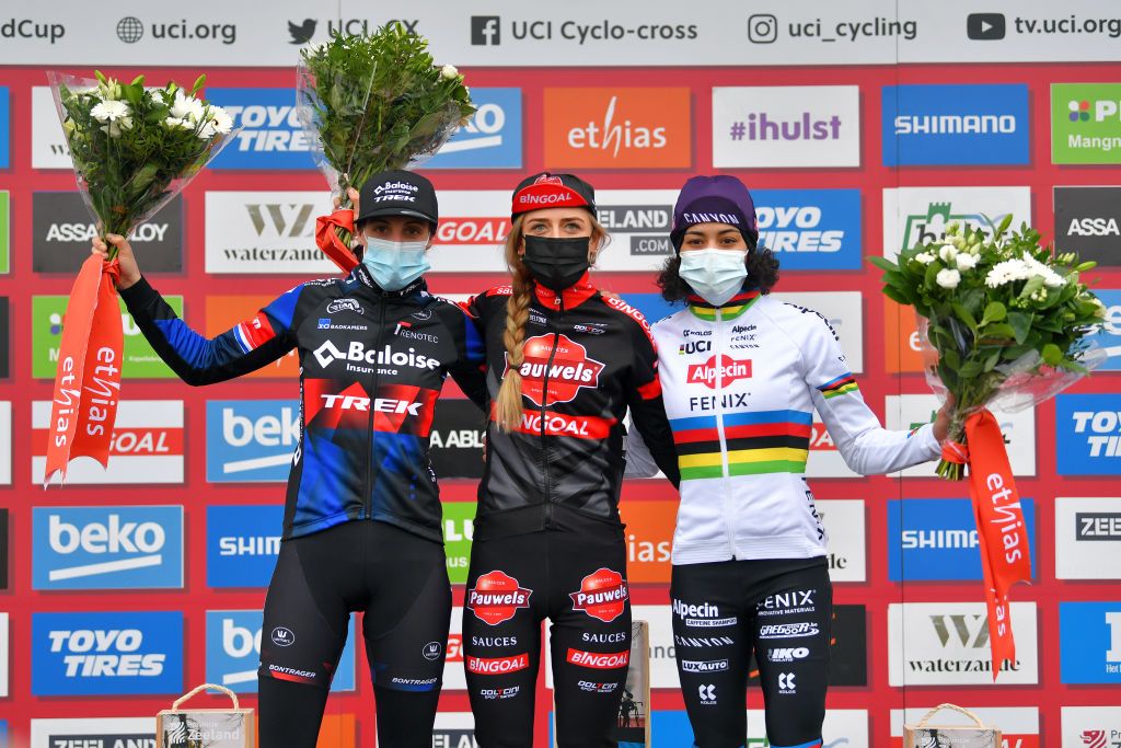 HULST NETHERLANDS JANUARY 03 Podium Lucinda Brand of The Netherland and Team Baloise Trek Lions Denise Betsema of The Netherland and Team Pauwels Sauzen Bingoal Ceylin Del Carmen Alvarado of The Netherland and Team AlpecinFenix Celebration Mask Covid safety measures during the 5th Vestingcross World Cup 2021 Womens Elite CX Vestingcross CXWorldCup Hulst on January 03 2021 in Hulst Netherlands Photo by Luc ClaessenGetty Images
