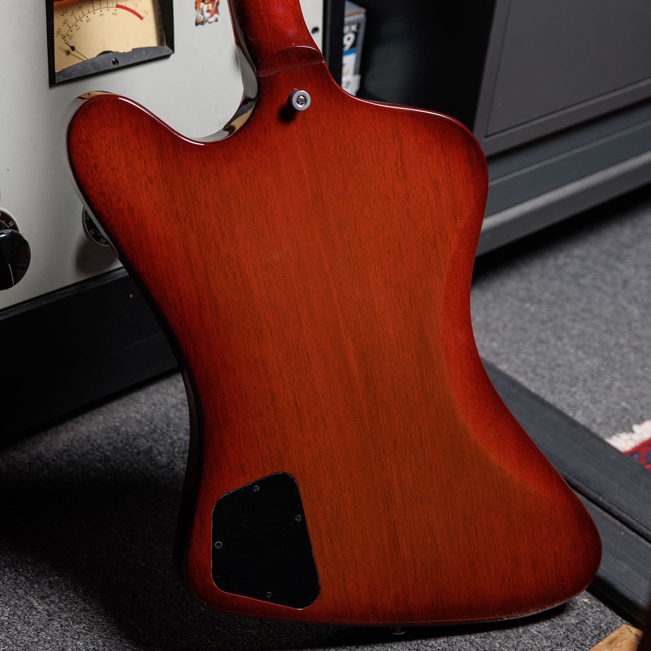 A photo showing a detail of the Gibson Firebird Platypus guitar in a recording studio setting