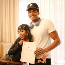 lovie simone and tk pose together smiling while getting ready backstage and holding up a script for forever season 2