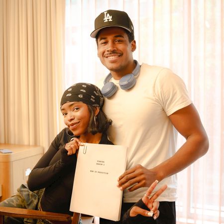 lovie simone and tk pose together smiling while getting ready backstage and holding up a script for forever season 2