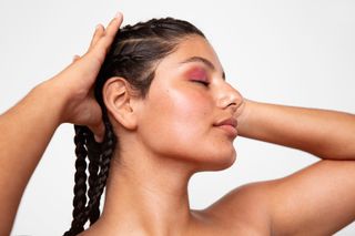 Woman with glowing skin showing her profile.