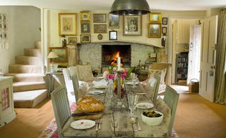 kitchen table with view of fireplace and framed prints above