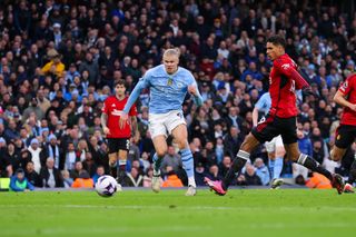 Erling Haaland scores for Manchester City against Manchester United in March 2024.