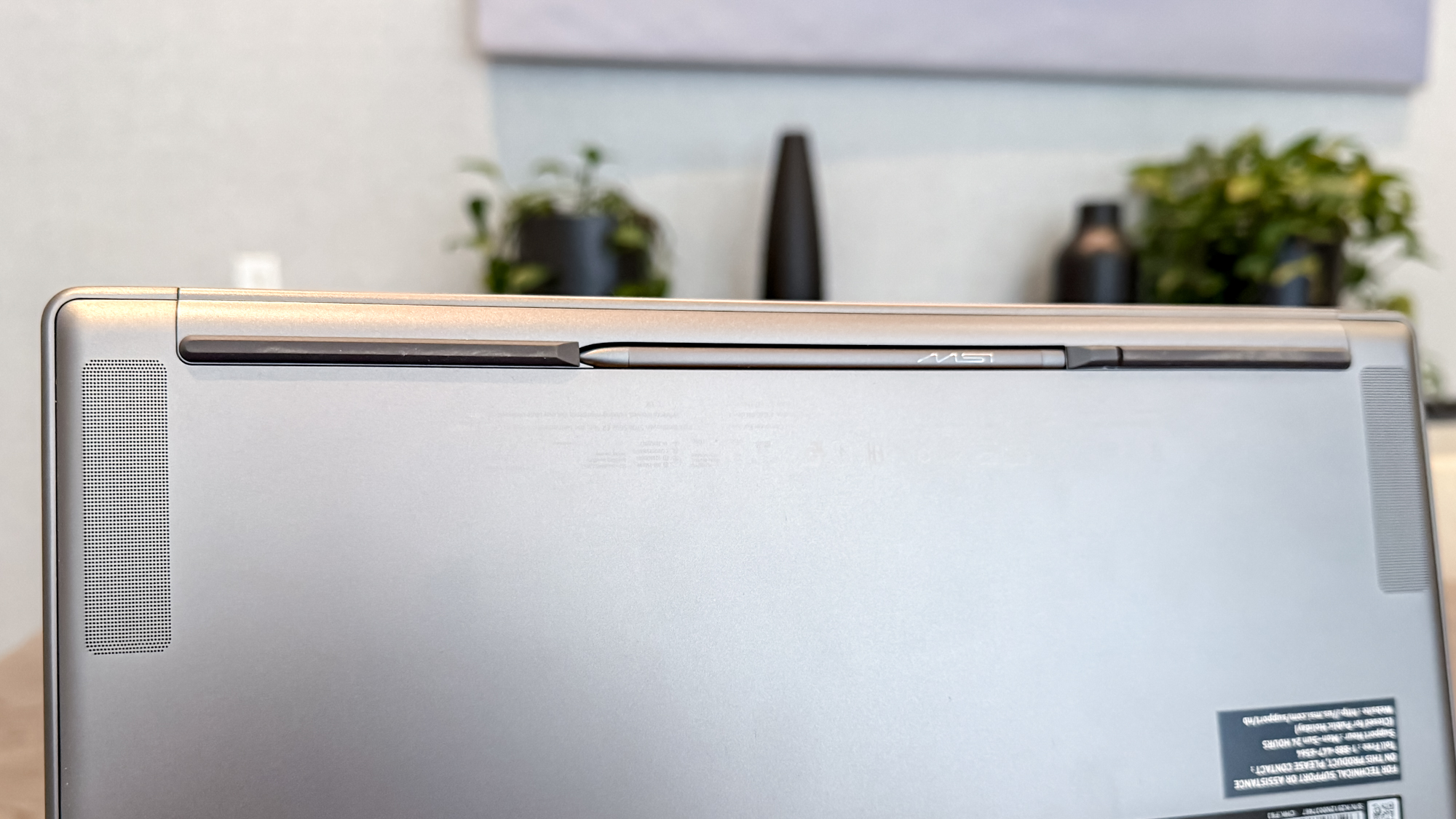 MSI Prestige 14 Flip AI+ stylus in its holder under the laptop