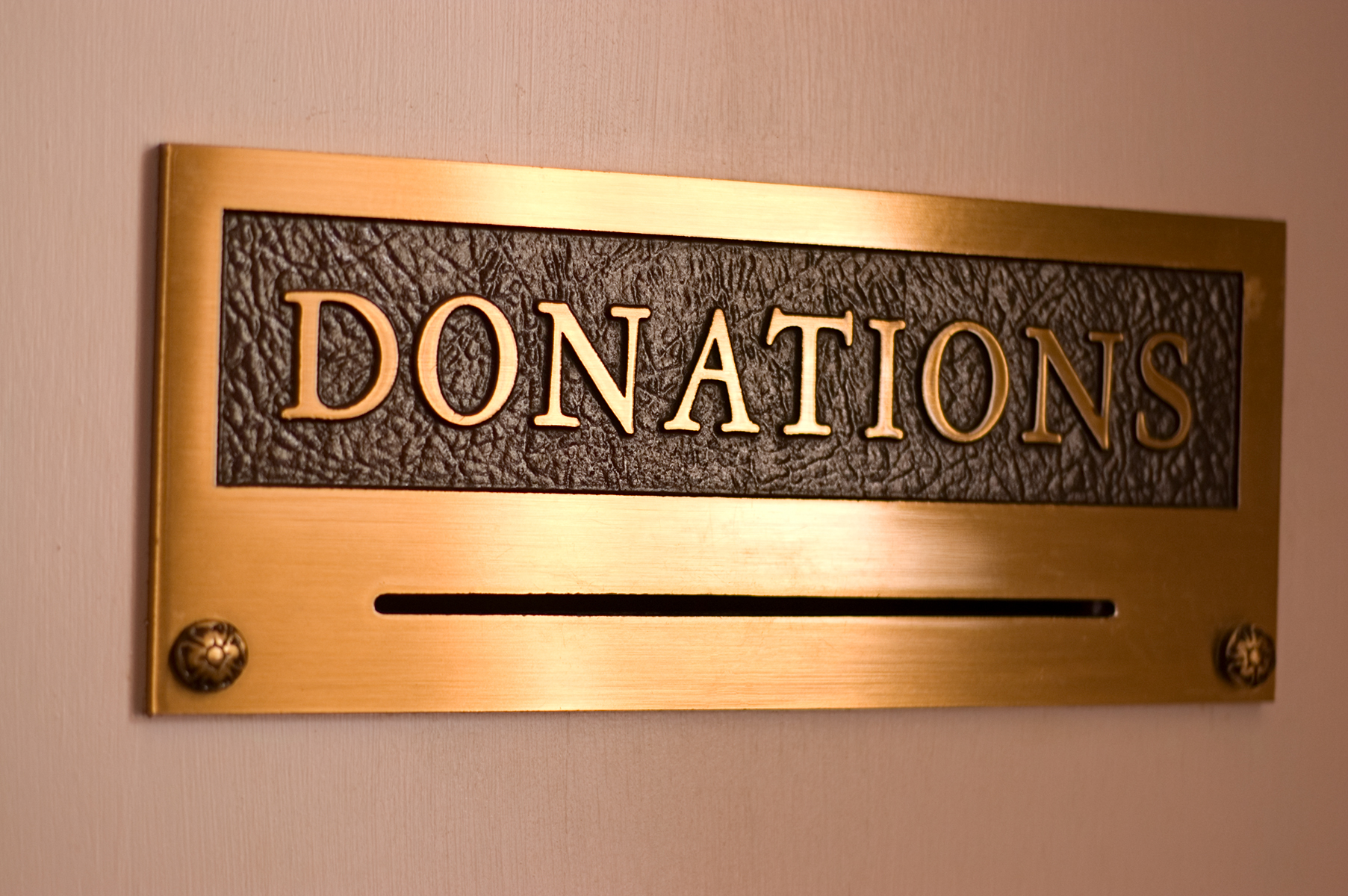 A gold-colored box marked "Donations" on a tan background