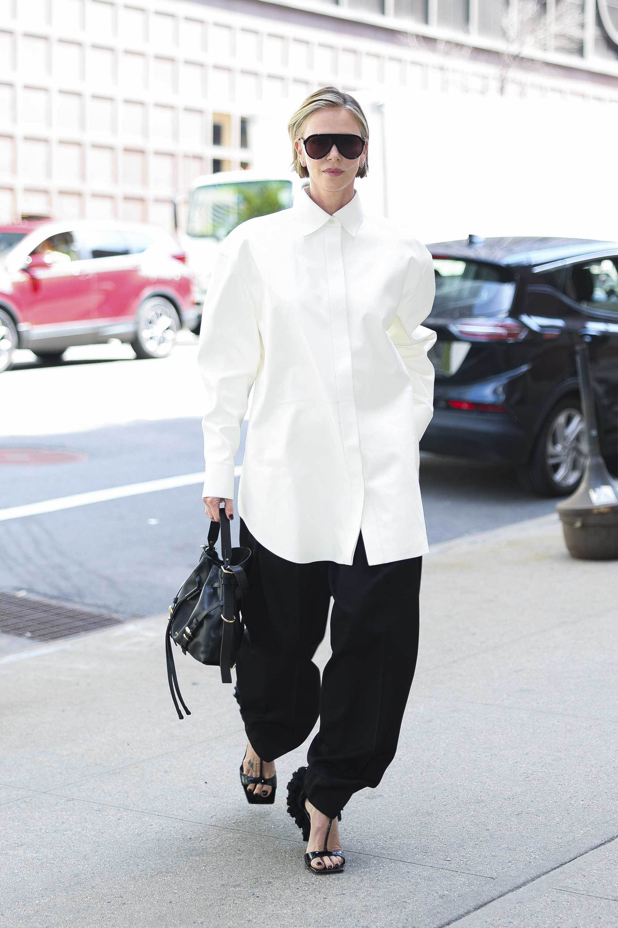 charlize theron on the apex press tour wearing black and white outfits