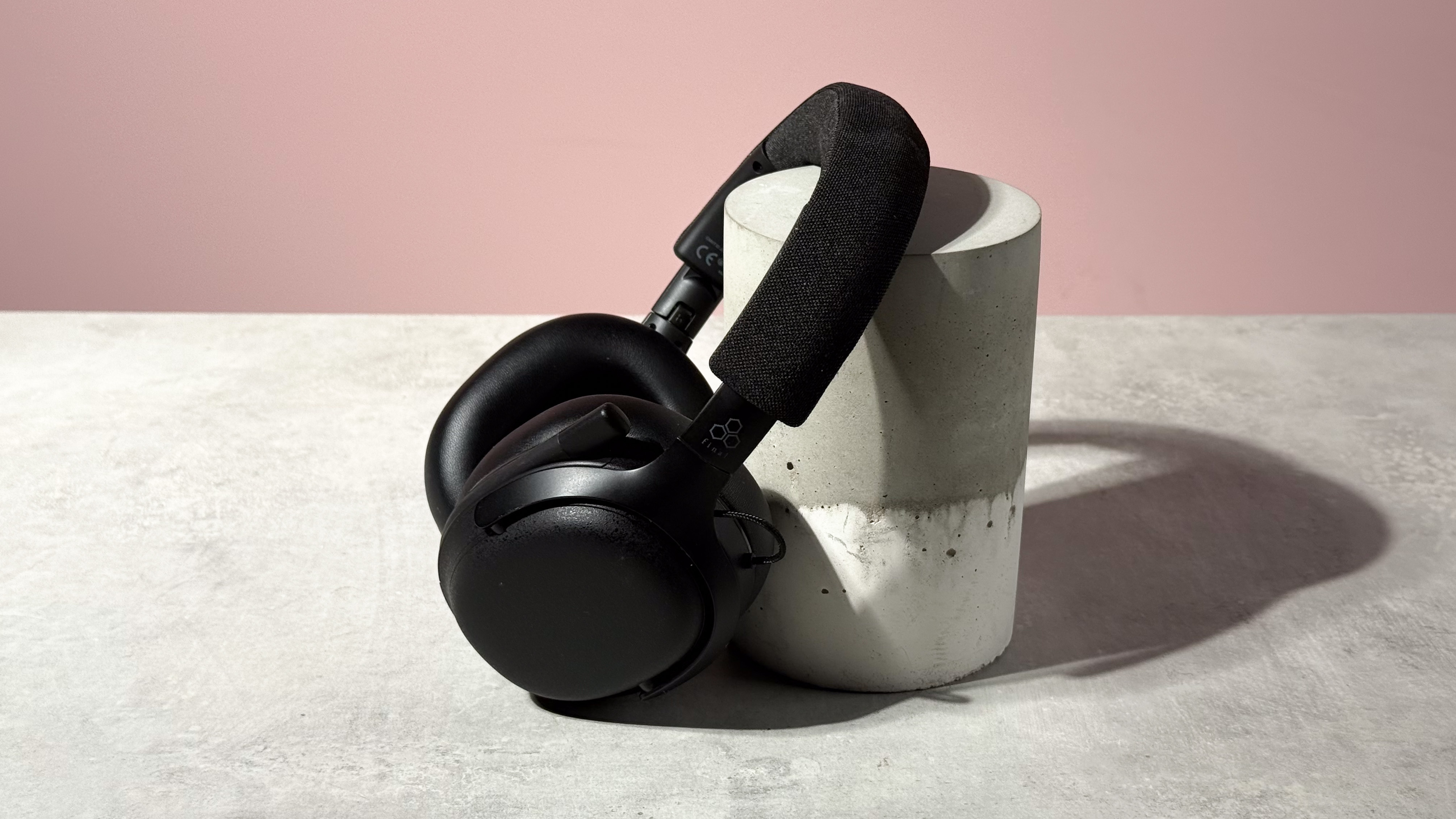 The Final VR3000 EX for Gaming unfolded and leant at a 45 degree angle against a stone and concrete cylinder.