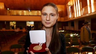 Ukraine's Maryna Viazovska presents her medal