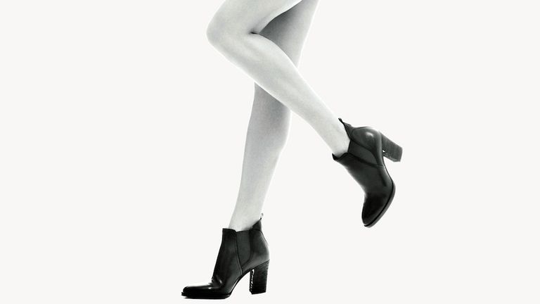 Black high heel boots on a model.