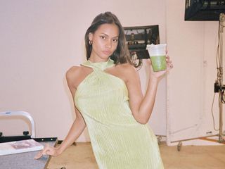 Girl in green dress holding a green juice
