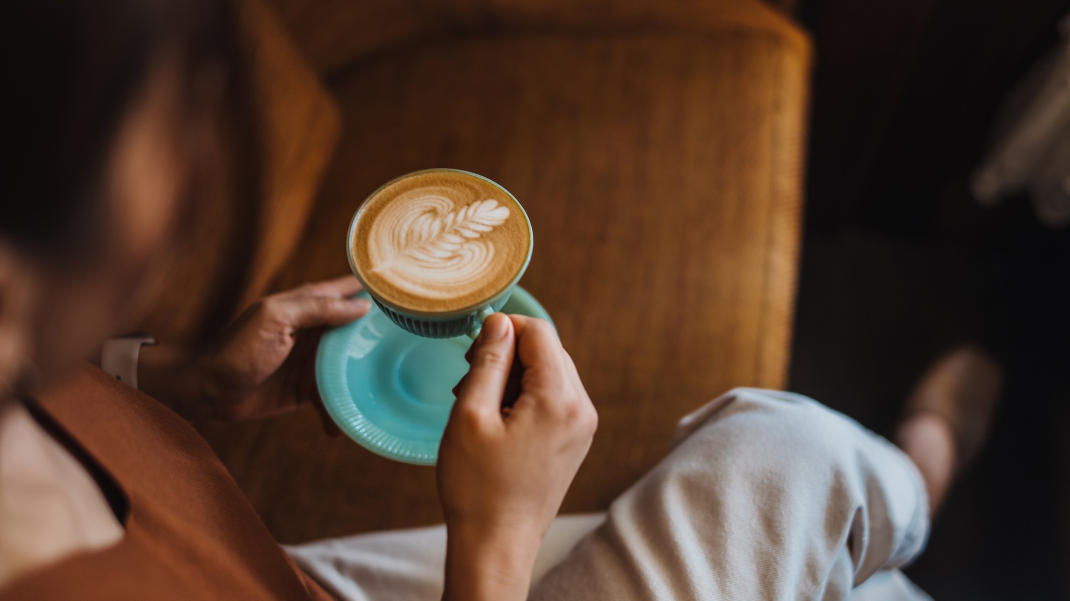 a woman sitting enjoying a cup of coffee