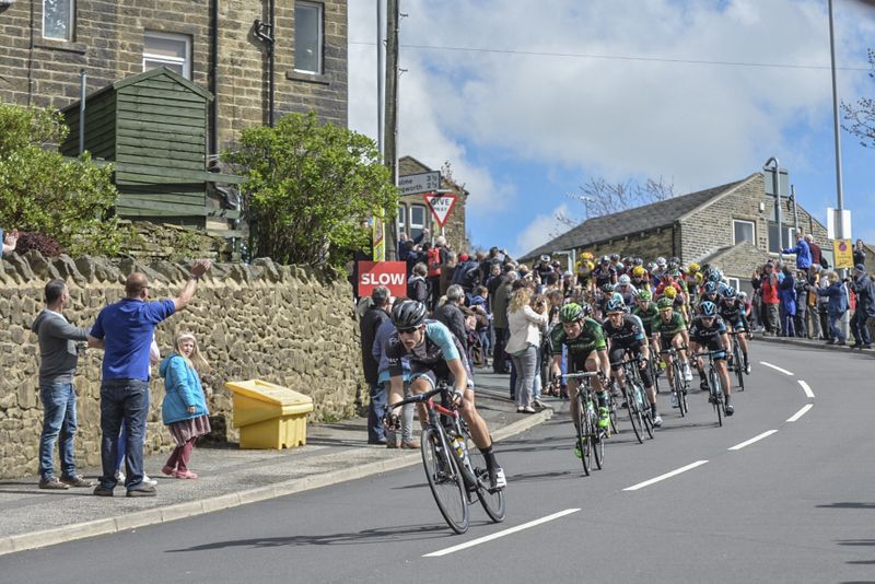 The peloton passes through the town of Haworth