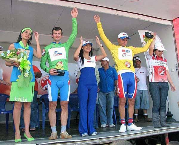 The podium, with stage winner Ivan Kovalev in green and overall leader Fabricio Quiros in yellow.