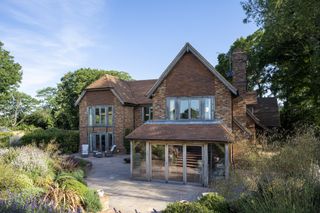 brick clad oak frame self build with glazing and garden