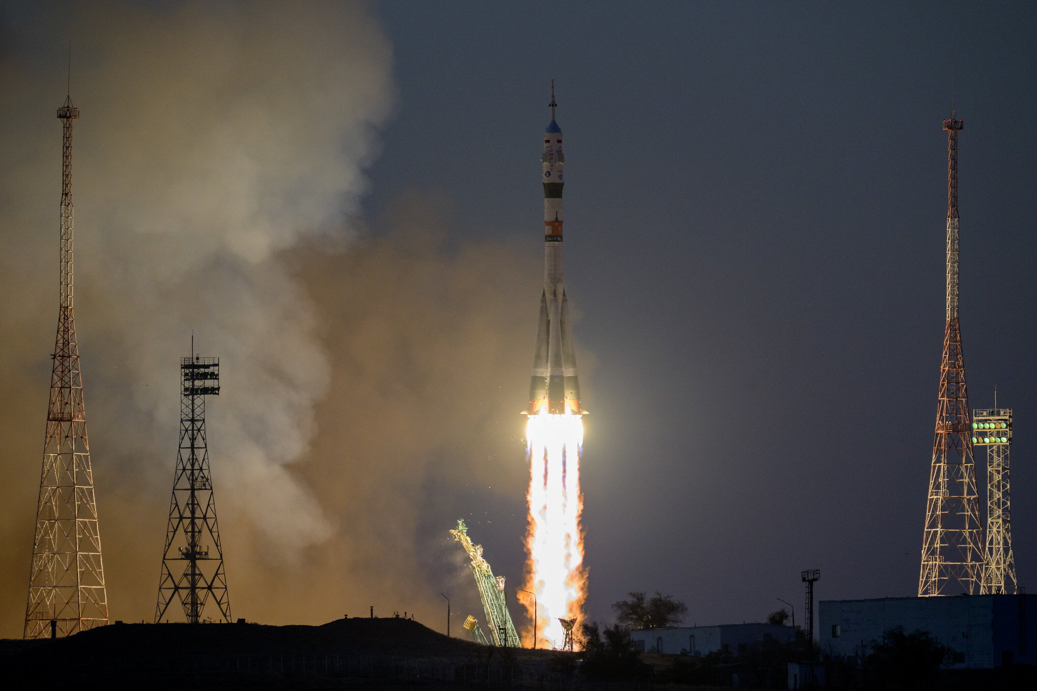 rocket lifting off atop plume