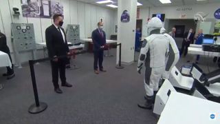 SpaceX CEO Elon Musk and NASA Administrator Jim Bridenstine speak with NASA astronauts Doug Hurley and Bob Behnken prior to a scrubbed launch on May 27, 2020. Hurley and Behnken successfully launched on their next attempt, on May 30, and spent two months at the International Space Station.