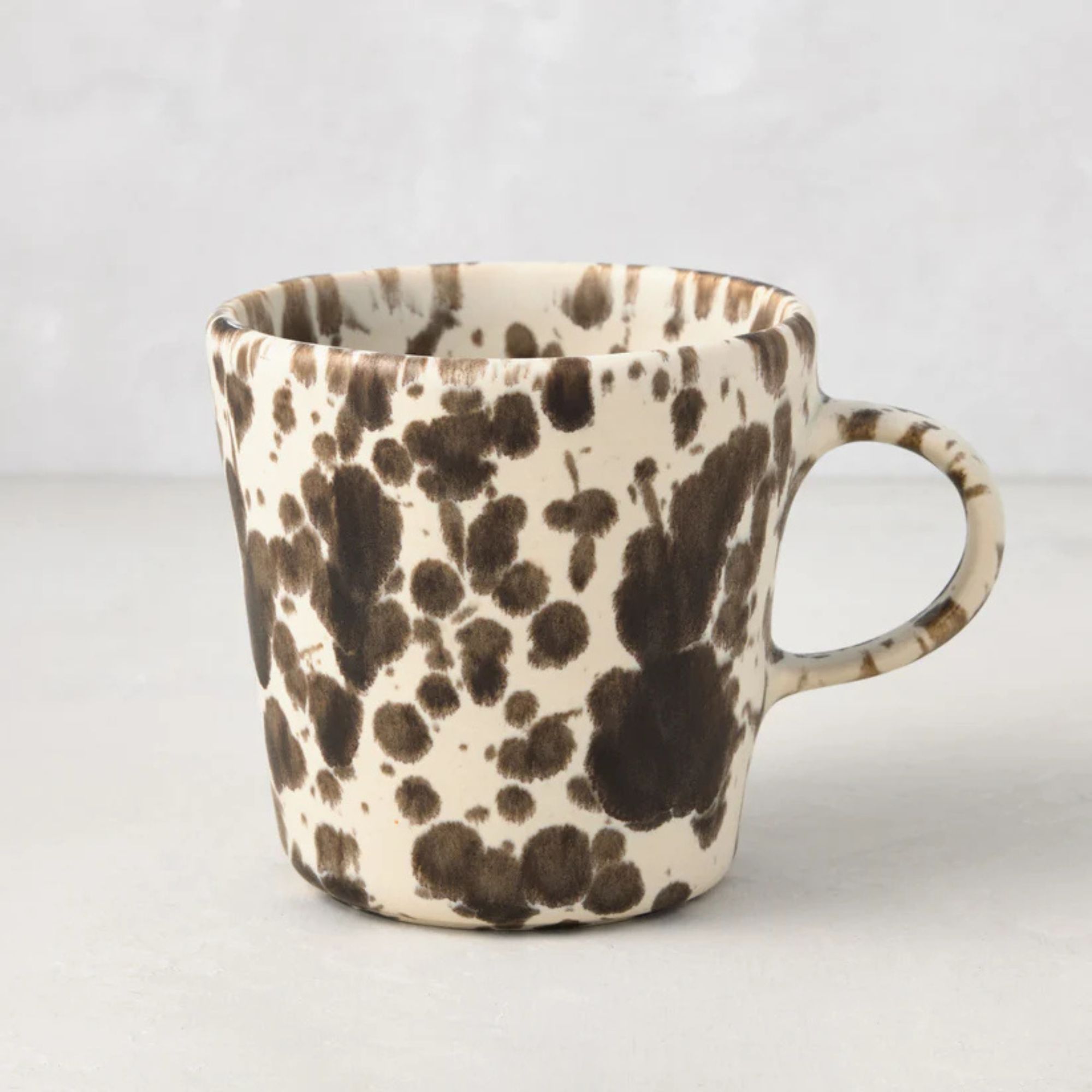 White ceramic mug with brown splatter print