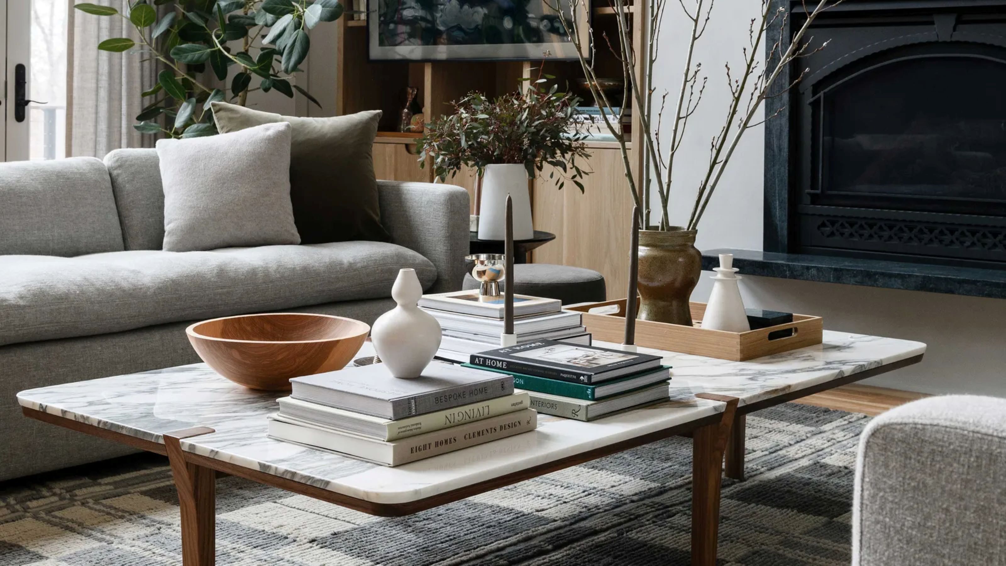 coffee table with stacks of books and decor objects