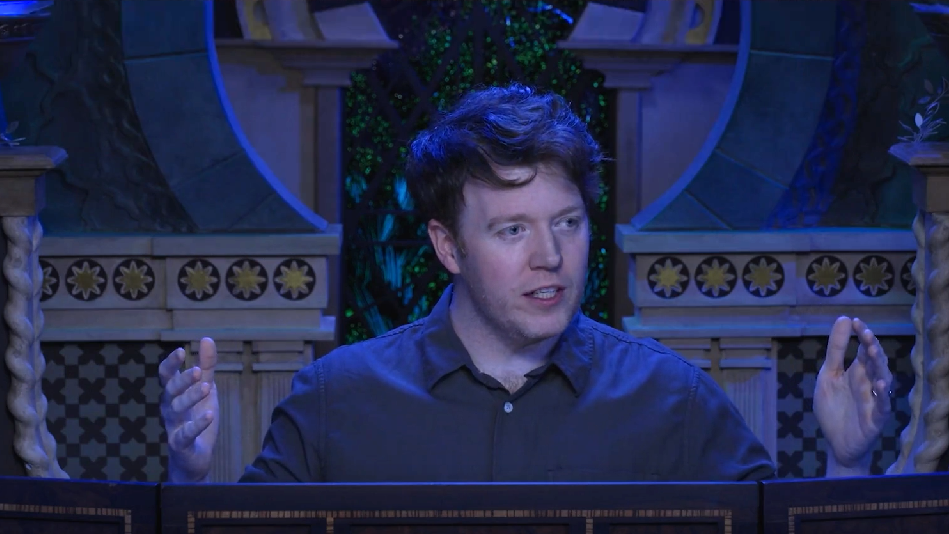 Brennan Lee Mulligan, DM of Critical Role, exposits with his hands held wide.
