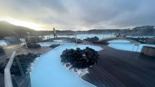 the blue lagoon geothermal spa in iceland with a hazy sunset