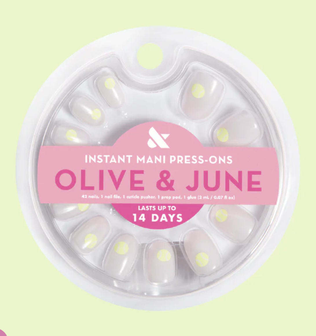 olive and june polka dot press ons on green background