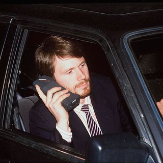 man calling phone in car