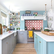 Bright and airy sky blue kitchen, with a red star tiled backsplash.