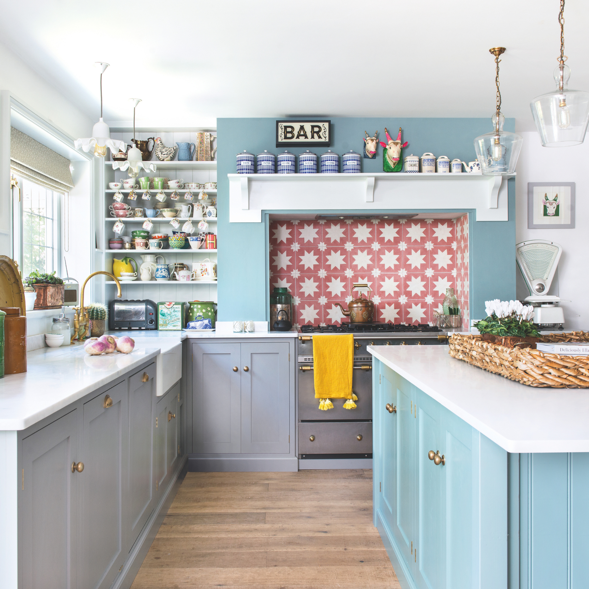 Bright and airy sky blue kitchen, with a red star tiled backsplash.