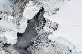 An aerial view of sea ice, showing where greenland is as well as the clouds.