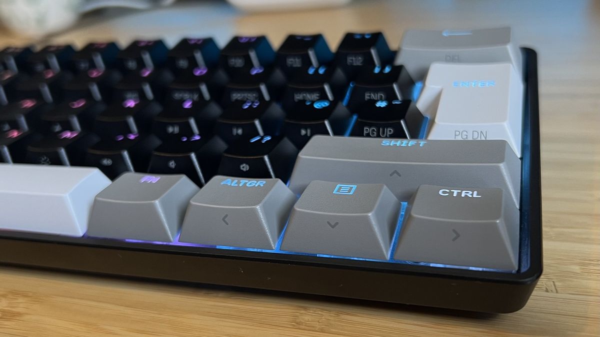 Close up on bottom right buttons of the Corsair Clipper Pro Mini 60 gaming keyboard, with dual-function arrow key legends on the sides