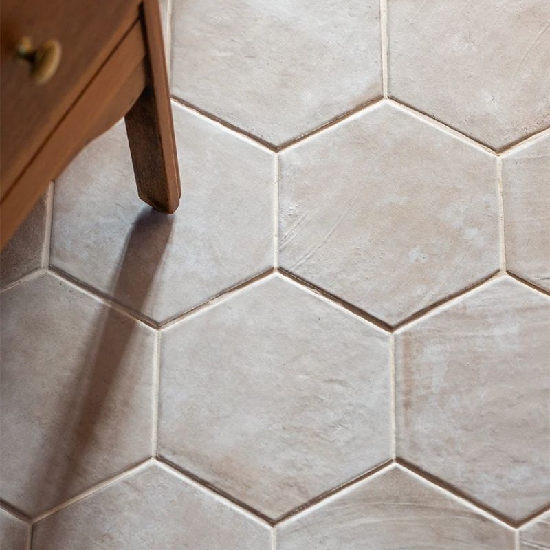 A natural stone hexagonal floor tile in a pale cream colour