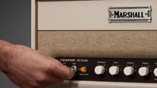 A user adjusts a Marshall Celestion 100