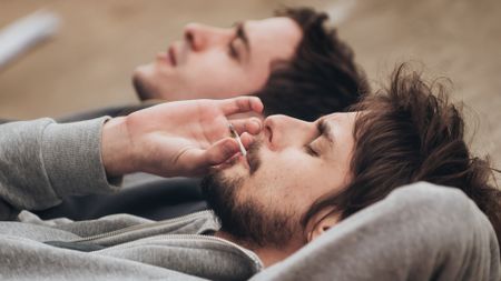 Stock photo of two friends smoking marijuana