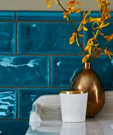 how to clean grout: blue tiles behind bathroom sink