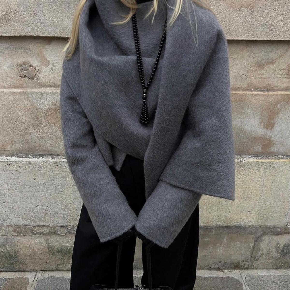 @signeemilieolesen outfit closeup in grey jacket with scarf detail and black tassel beaded necklace